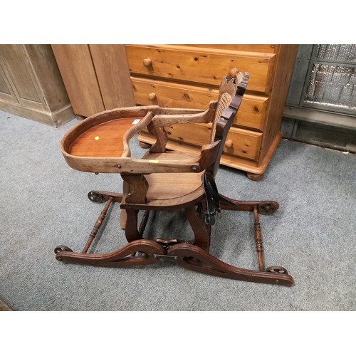 857 - Antique, metamorphic, wheeled highchair/rocker with cane backrest.