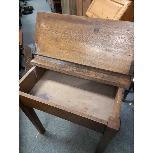 861 - Lift-top school desk with ink well. L71cm, W50cm, H76cm.