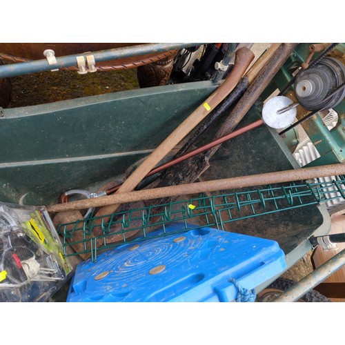 123A - Green plastic barrow with contents inc new loppers,long handled tools, blue trolley, shooting stick ... 