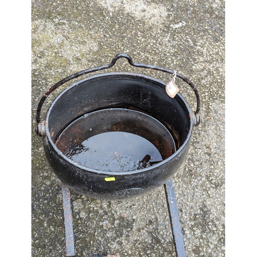 70 - Large, cast iron cooking pot/cauldron + 2 fire dogs. 