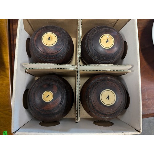 889 - 2 sets of 4 Henselite lignum vitae lawn bowls in original boxes.