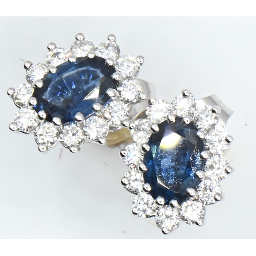 23 - Pair of 18ct white gold, sapphire and diamond oval cluster ear studs, length 10mm, gross weight 1.93... 