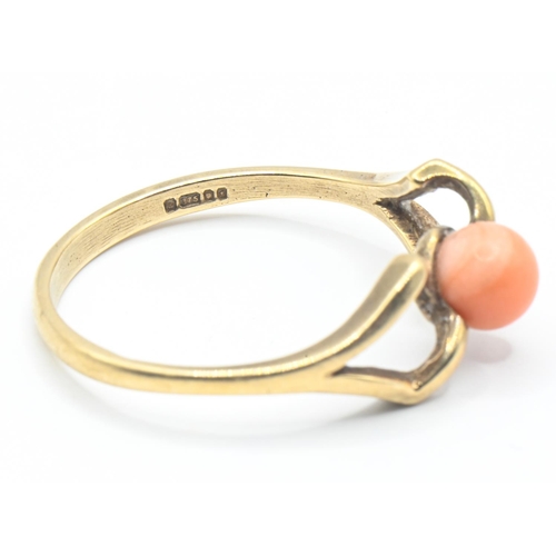 27 - 9ct gold ring set with coral in an open work twist, size P, gross weight 2.04 grams