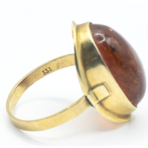 43 - 8ct gold and oval cabochon amber ring, stamped 333, size Q1/2, gross weight 3 grams