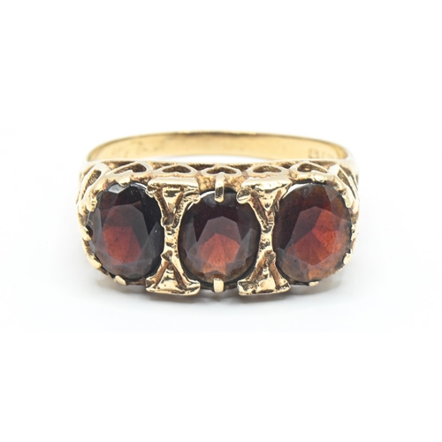 48 - 9ct gold and three stone garnet ring, hallmarked London 1977, size O1/2, gross 2.82 grams