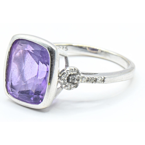 62 - 9ct white gold, amethyst and diamond ring, the amethyst measuring approximately 12mm x 9mm in a rub ... 