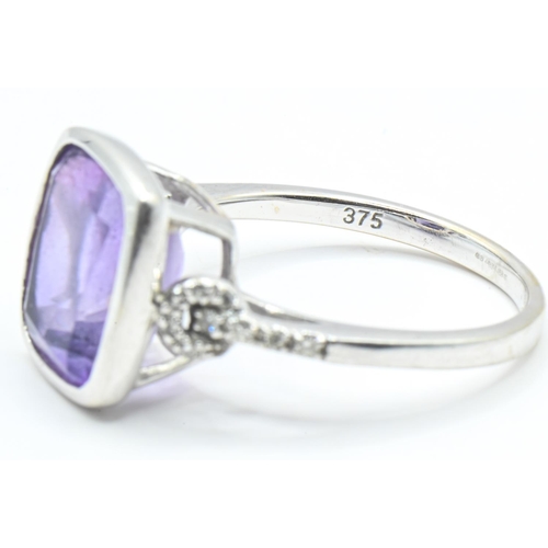 62 - 9ct white gold, amethyst and diamond ring, the amethyst measuring approximately 12mm x 9mm in a rub ... 