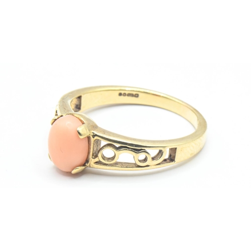 92 - 9ct gold ring with openwork shoulders set with an oval shaped coral, size P1/2, gross weight 3.13 gr... 