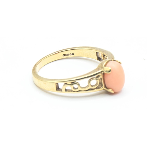 92 - 9ct gold ring with openwork shoulders set with an oval shaped coral, size P1/2, gross weight 3.13 gr... 