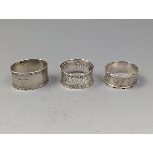 383 - Three silver napkin rings, various makers and dates, two initialled, gross weight 78.1 grams, togeth... 