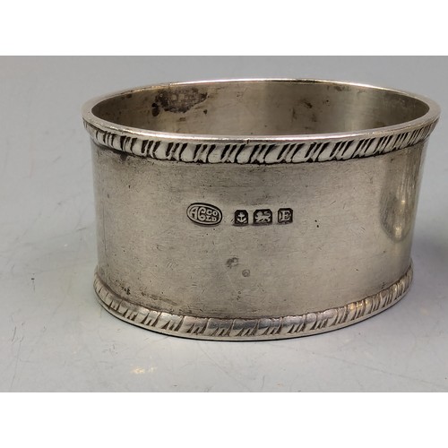 383 - Three silver napkin rings, various makers and dates, two initialled, gross weight 78.1 grams, togeth... 