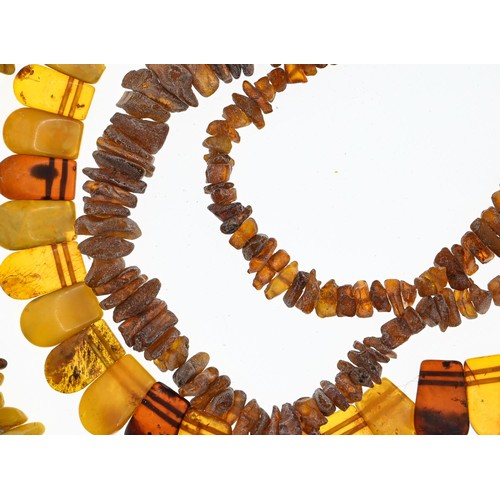 238 - Collection of three bracelets and two necklaces in rough cut amber, gross weight 140 grams