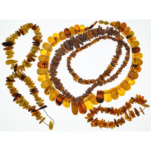 238 - Collection of three bracelets and two necklaces in rough cut amber, gross weight 140 grams