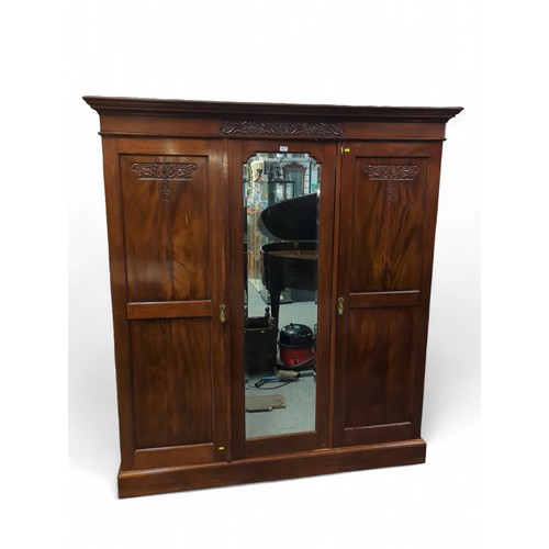 636 - Large mahogany triple wardrobe with central mirror. W178cm, D56cm, H199cm.