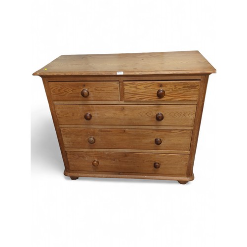 649 - Large pine 2 over 3 chest of drawers. On bun feet. W116cm, D52cm, H104cm.