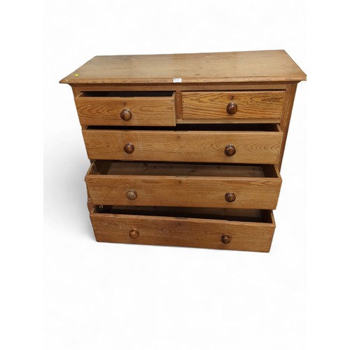 649 - Large pine 2 over 3 chest of drawers. On bun feet. W116cm, D52cm, H104cm.