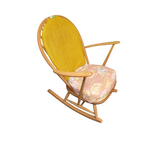 696 - Ercol Windsor Tub-Rocking Chair. Model 470, natural finish. Includes cushions for pattern use only.