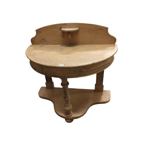 682 - Strip pine half moon wash stand with small central shelf and lower shelf. W99cm, D approx. 50cm, H98... 