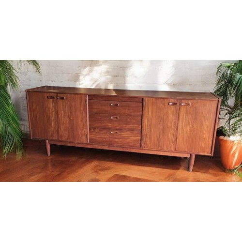 690 - Large, teak, Younger mid-century sideboard. 3 central drawers and 2 outer cupboards. L213cm, D36cm, ... 