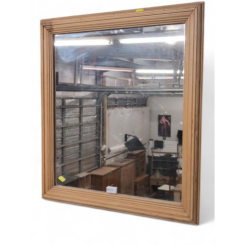 629 - Strip pine-framed mirror. W64cm, H70cm.