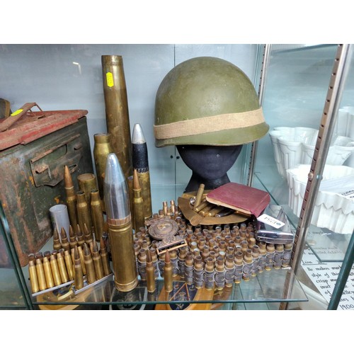 1254 - Empty shell cases, military helmet, National Defence Notebook etc.