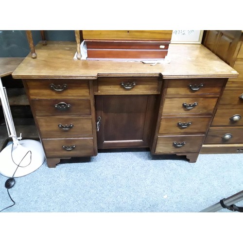 544 - Oak desk with nine drawers and central cupboard (with key) L115 x D57 x H73cm