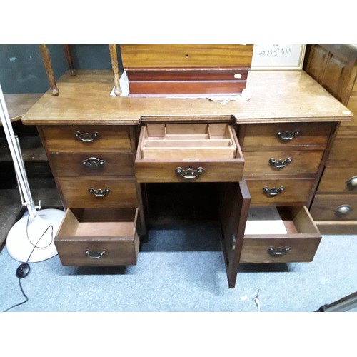 544 - Oak desk with nine drawers and central cupboard (with key) L115 x D57 x H73cm