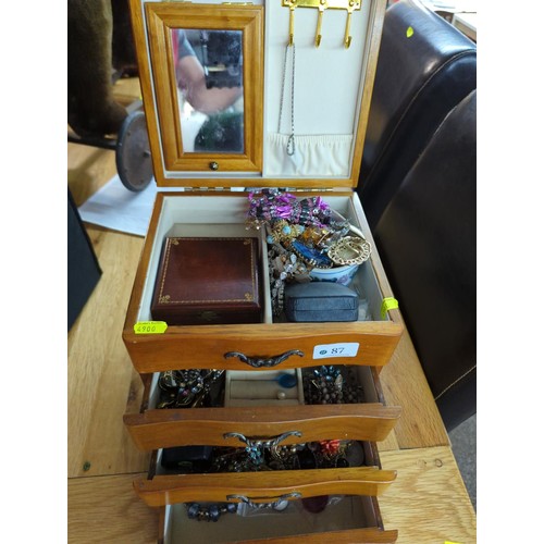 87 - Wooden 4 drawer jewellery box with costume jewellery contents. 