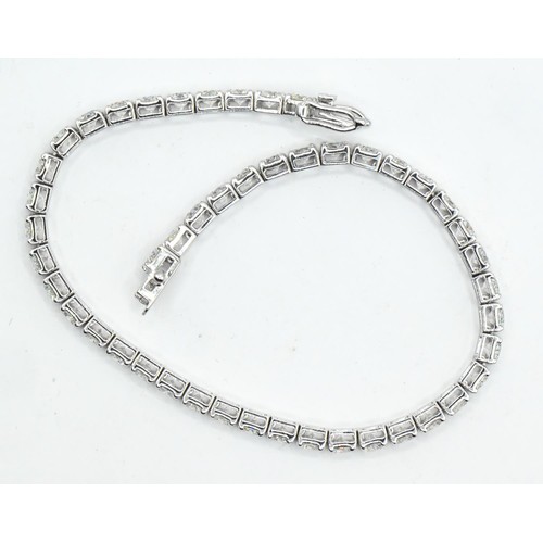 27 - 18ct white gold and diamond line bracelet, comprising an articulated line of 47 claw-set brilliant-c... 