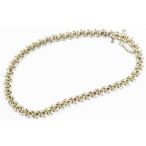 39 - 10ct gold and diamond line bracelet, with S-shape gold spacers, length 190mm, gross weight 7.48 gram... 