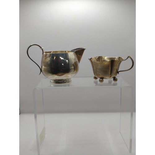 104 - Silver milk jug hallmarked Birmingham 1973 plus silver cream jug, hallmarked rubbed, total... 