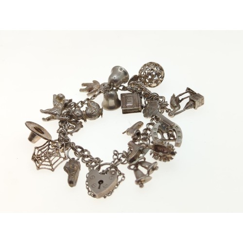 59 - Silver charm bracelet, wt 47gms