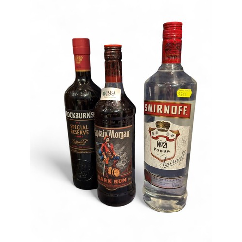 499 - 1 litre bottle of Smirnoff, 70 cl Captain Morgan dark rum, 75cl Cockburn No 1 special reserve Port