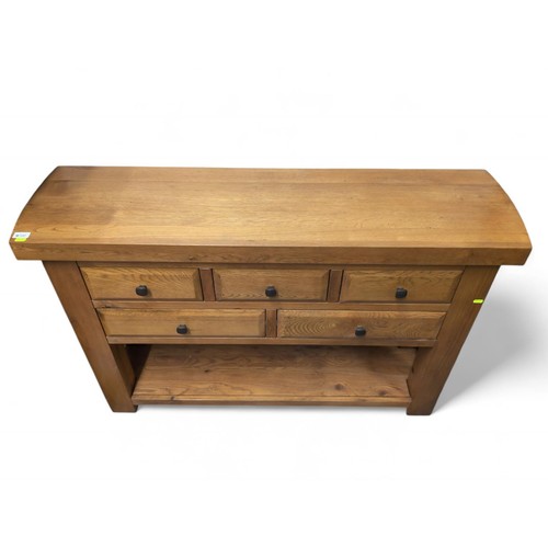 541 - Solid oak 5 drawer sideboard. W130cm D36cm H85cm