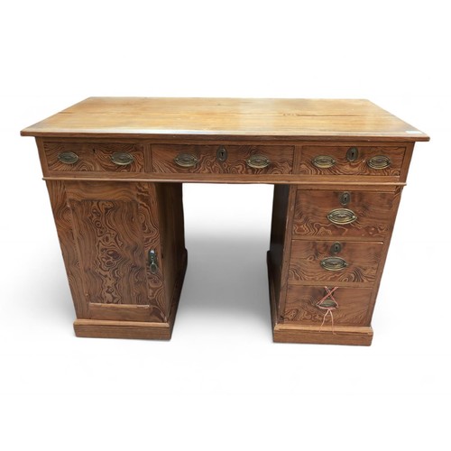 568 - An early C20 pitch pine pedestal desk. With 3 top drawers, sat on pedestals of single cupboard with ... 