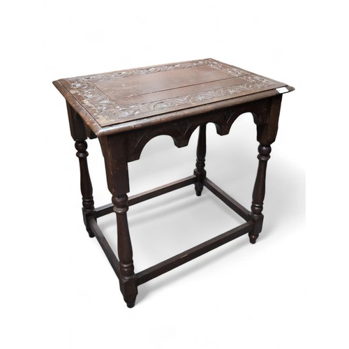 574 - A carved oak occasional table. W66cm D46cm H72cm