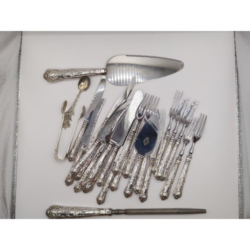 124 - Silver sugar nips, 9 silver handled cake knives, 6 dessert forks , 3 cake forks plus small & lar... 