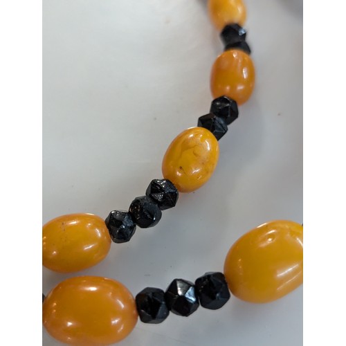 70 - Amber and black bead necklace Approx L780mm approx 54g