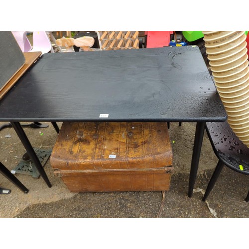 113 - Contemporary black dining table with tapered supports together with two matching benches. Table W110... 