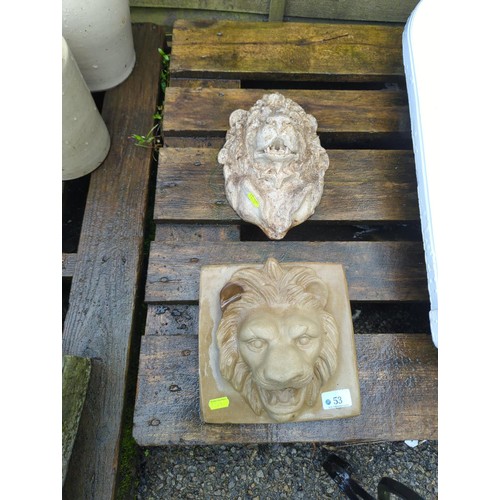 53 - 2 concrete lion heads. Largest length 25cm.