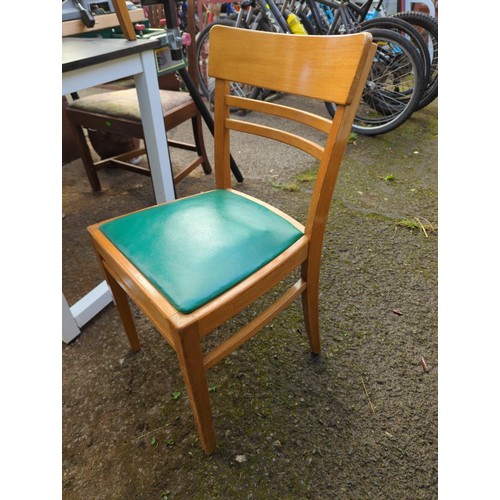 99 - 4 dining chairs with green vinyl upholstery.