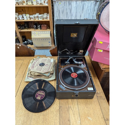 719 - HMV portable gramophone together with a selection of gramophone records