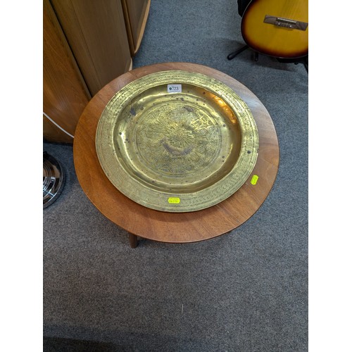 723 - Mid century modern style occasional table (d52cm h43cm) together with decorated brass charger (d40.5... 