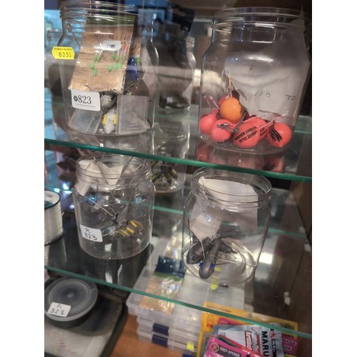 823 - Fishing weights, hooks and lures in cabinet over three shelves