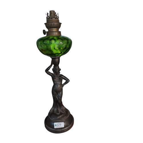 379 - Figurative oil lamp supporting green glass shade, H44cm + small blue and white ceramic oil lamp.