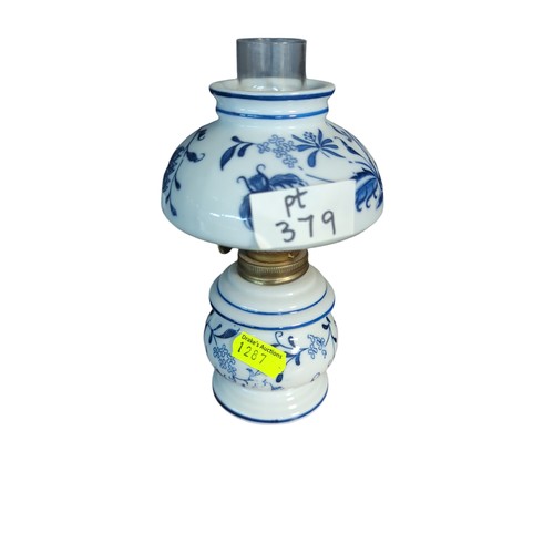 379 - Figurative oil lamp supporting green glass shade, H44cm + small blue and white ceramic oil lamp.