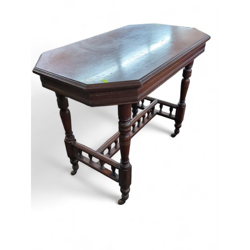 435 - Octagonal mahogany occasional table on casters. W92cm D53cm H73cm.