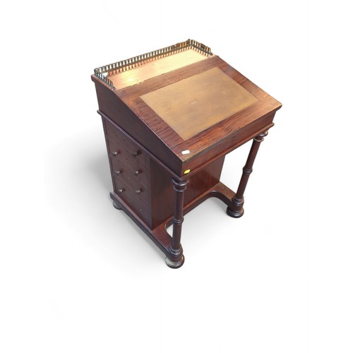 54 - Davenport writing desk with brass gallery and leather top. On casters. W53cm D52cm H83cm.