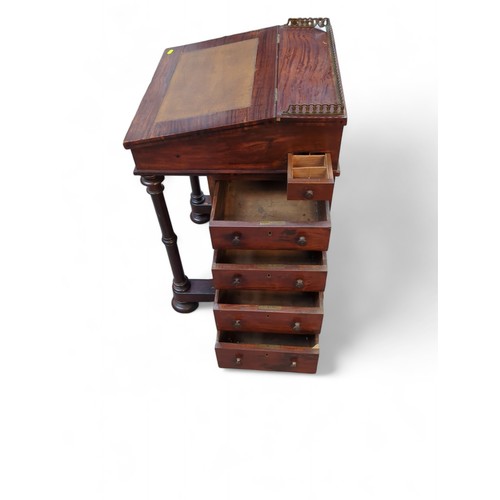 54 - Davenport writing desk with brass gallery and leather top. On casters. W53cm D52cm H83cm.