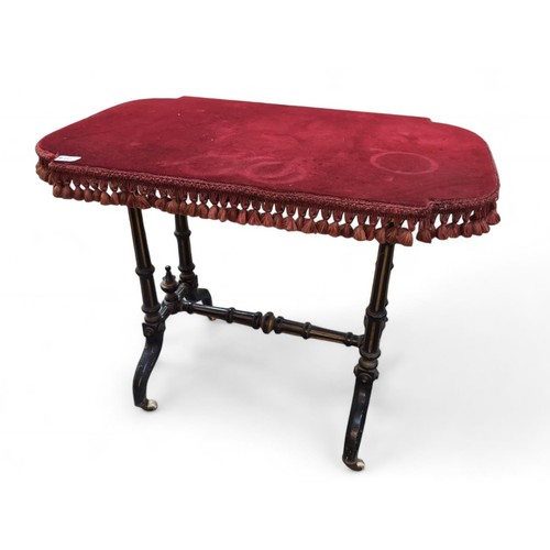 60 - Victorian ebonised side table on casters with a replacement fringed velvet top. W872cm D31cm H65cm.